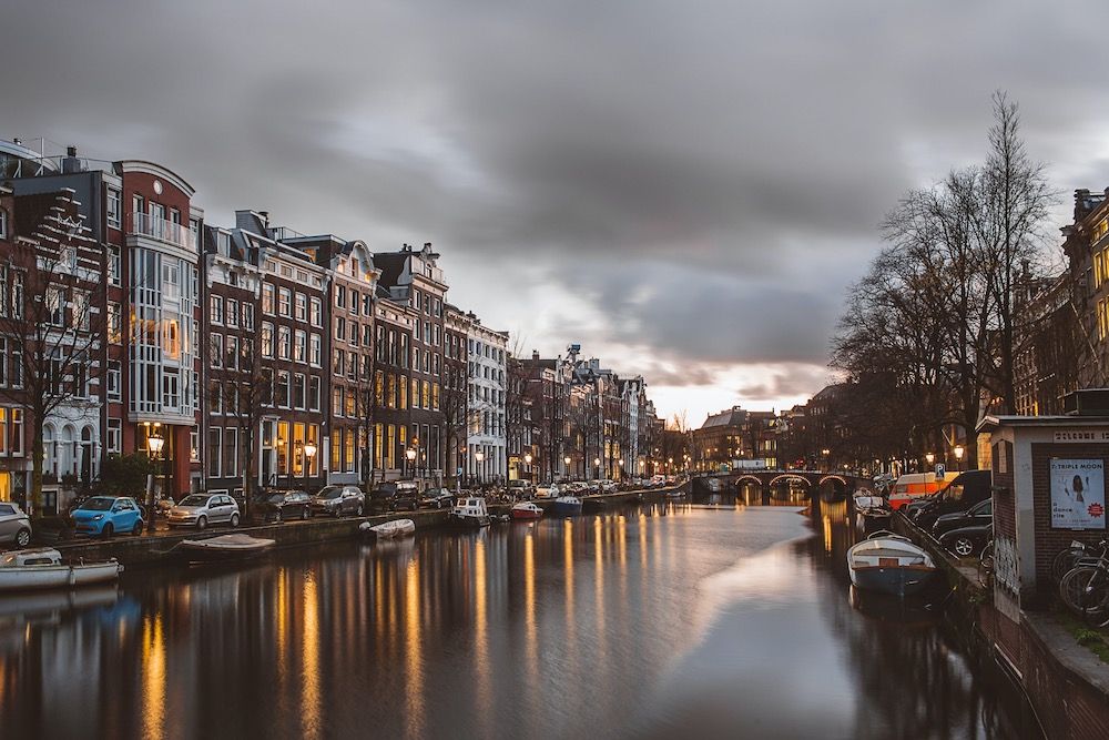 Beautiful canal in Amsterdam seems stormy as city restaurants work through pandemic changes. Article by Table Sage team